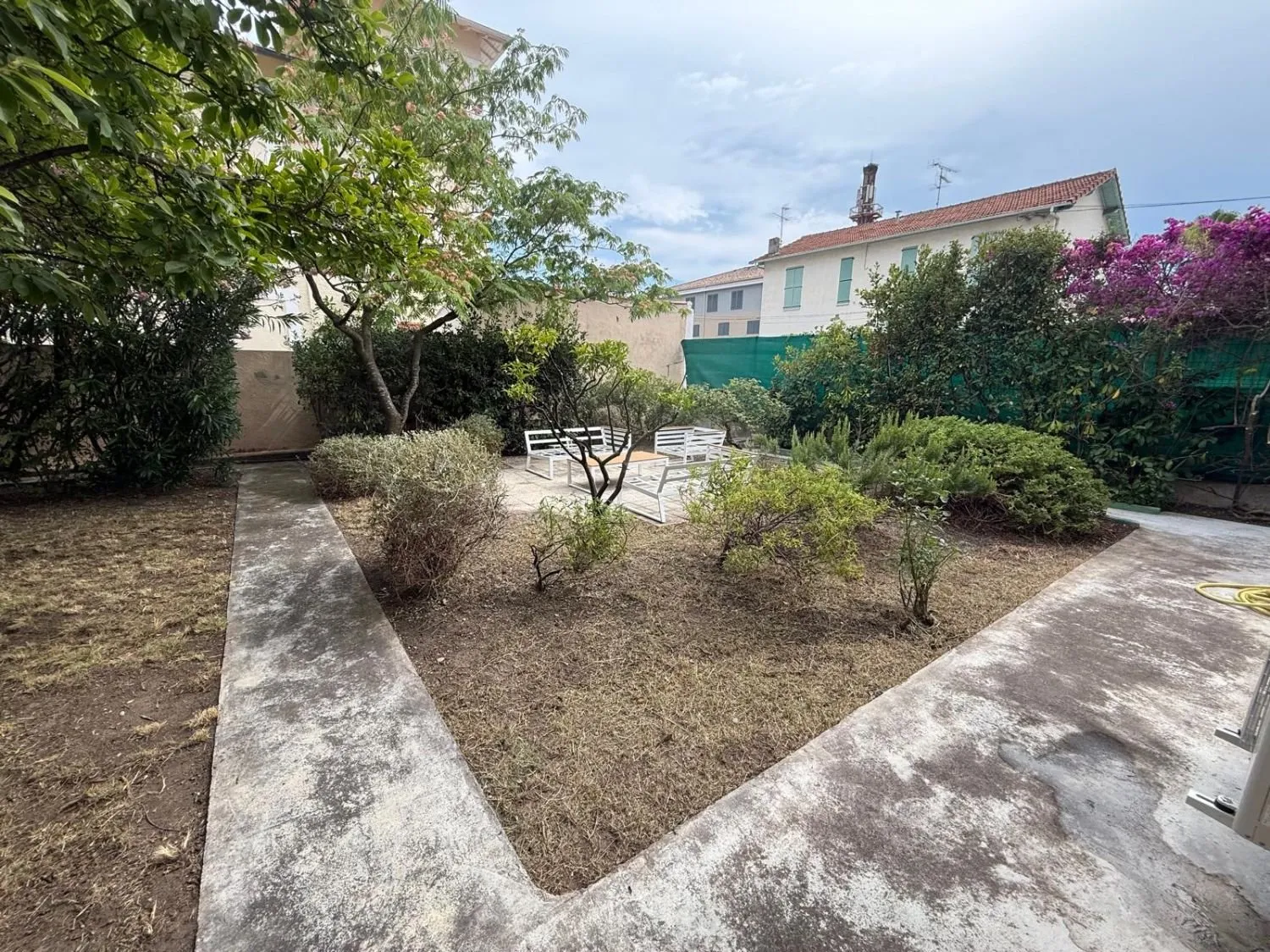 Jardin débroussaillé, arbustes taillés et allées dégagées